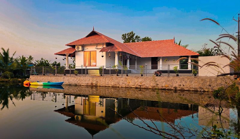Mangalath Holidays: the Kerala-style house on the water at Munroe Island, with kayaks at the edge